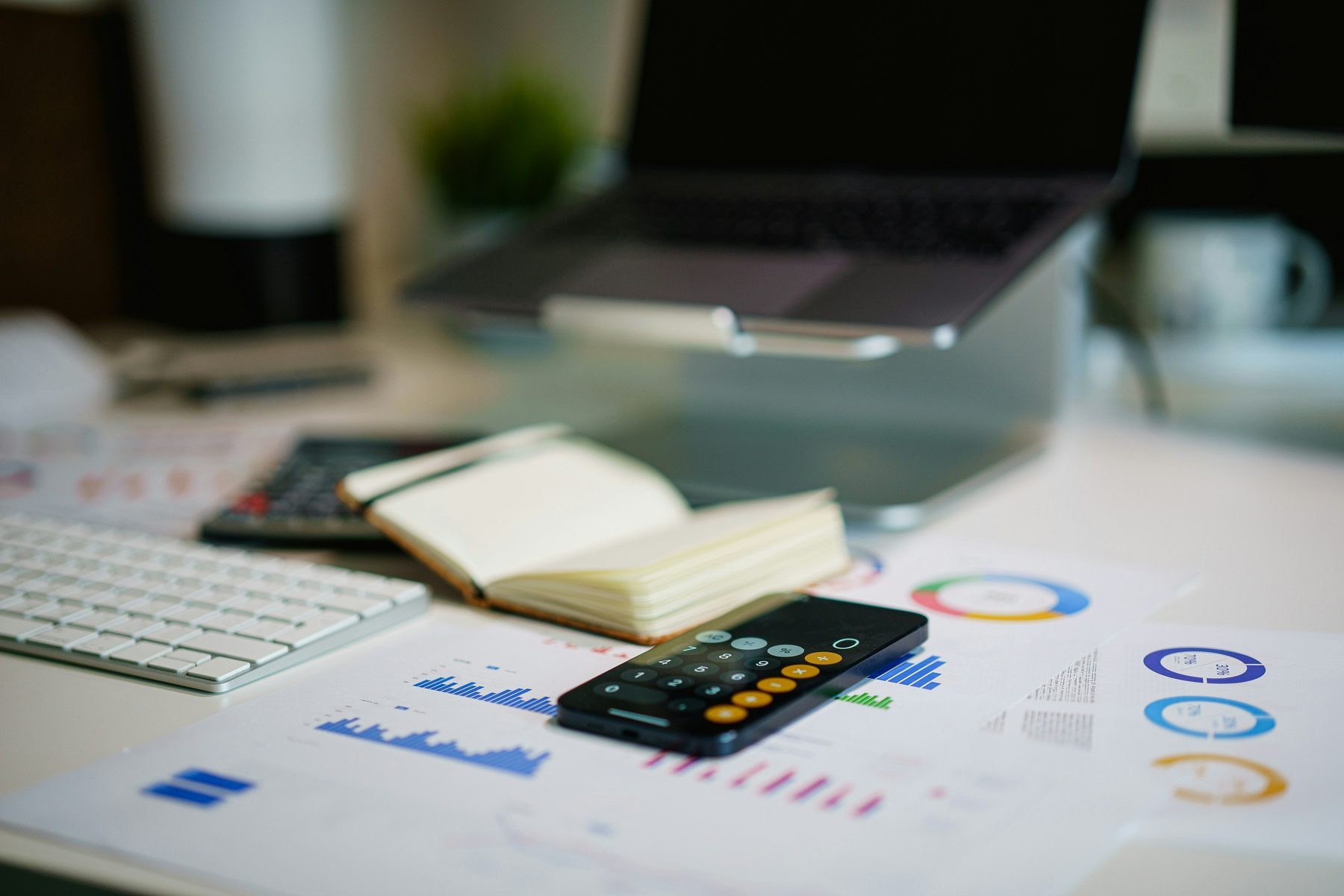 Financial charts, calculator and desk used to illustrate insurance analytics